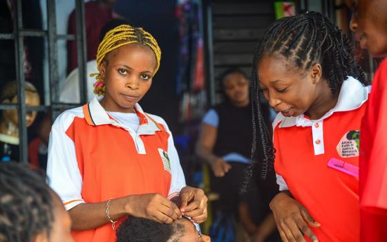 Veronica Boniface (left) says she wants to be a lawyer to help victims of child labor. (Patrick Egwu)