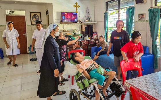 Sr. Catharina Ginah cares for children and adolescents with disabilities at Bhakti Luhur, a care home overseen by the sisters of the Association of Lay Missionary Institutions, while her lay partner assists in the background. (Jacobus Lato)