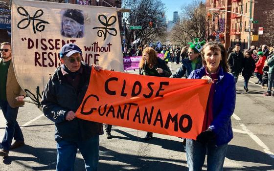 Colleen Kelly, right, marches with a banner calling for the closure of the U.S. military prison at Guantánamo Bay, Cuba, during a St. Patrick's Day parade in 2020. (CNS/Courtesy of Colleen Kelly, September 11th Families for Peaceful Tomorrows)
