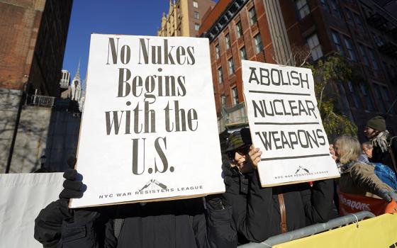 Demonstrators hold signs as they face United Nations headquarters in New York City during a rally to abolish nuclear weapons Nov. 28, 2023. Catholic Worker and Pax Christi members were among the participants. (OSV News/Gregory A. Shemitz)