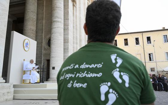 A young man listens to Pope Leo XIV during a meeting between the pope and young people taking part of the "Go! Franciscan Youth Meeting 2026" in Piazza Santa Maria degli Angeli in Assisi, Italy, Aug. 6, 2026. (OSV News/Vatican Media/Simone Risoluti)