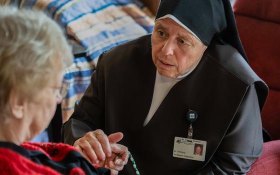 A Carmelite Sister comforts a resident Aug. 21, 2026, at St. Patrick's Residence in Naperville, Ill. (OSV News/Courtesy of Becket)