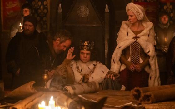 Tom Hollander as Treasurer Hales, Woody Norman as King Richard II and Katherine Waterston as The Countess interact in director Paul Greengrass' "The Uprising," which opens in theaters Sept. 11.(Focus Features/Betina La Plante)