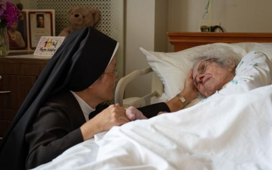 A Carmelite Sister comforts a resident Aug. 21, 2026, at St. Patrick’s Residence in Naperville, Ill. (OSV News/Courtesy Becket)