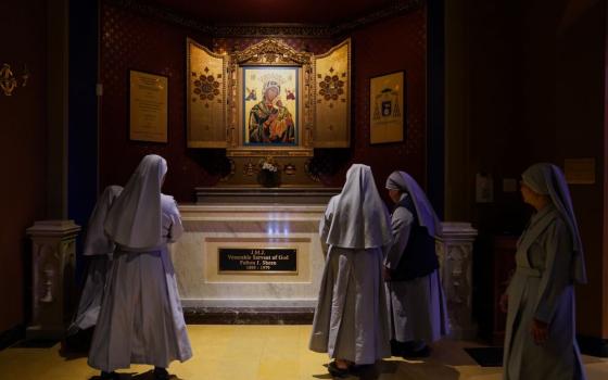 Nuns pray at the tomb of Archbishop Fulton Sheen at the Cathedral of St. Mary of the Immaculate Conception in Peoria, Ill., on July 15, 2026. Sheen is to be beatified Sept. 24 in St. Louis. (AP/Jessie Wardarski)