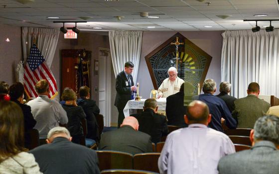 Fr. John Davis celebrates Mass, assisted by a volunteer, at the Pentagon Memorial Chapel in Arlington, Va., during the National Day of Prayer May 5, 2016. The chapel, which opened on the first anniversary of the 9/11 terrorist attack on the Pentagon, was built directly at the impact site where the hijacked plane crashed into the Pentagon. (OSV News/Courtesy of DOD/Dave Vergun)