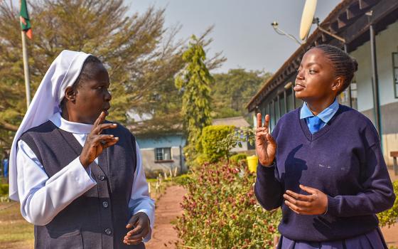 Baptistine Sr. Charity Kaloto engages with Kabwe Mukuka, a Grade 11 student at St. Joseph School for the Deaf in Lufwanyama, Zambia. (Derrick Silimina)