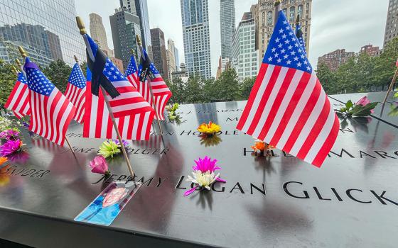 Flags and flowers are placed in the inscribed names at the National September 11 Memorial in New York on Sept. 10, 2025. (AP/Donald King)
