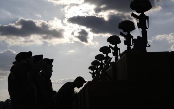 U.S. soldiers pay their respects in front of fallen soldier memorials following a memorial ceremony held at Fort Hood, Texas, Nov. 10, 2009, for victims of the Nov. 5, 2009, shooting at the Fort Hood Army post. (OSV News/Reuters/Jessica Rinaldi)