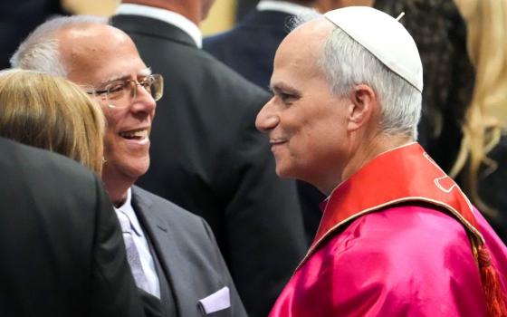 Pope Leo XIV greets his older brother, Louis Prevost, in St. Peter's Basilica following the pope's inaugural Mass at the Vatican May 18, 2025. (CNS/Lola Gomez)