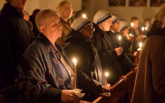 Worshippers at the Siberia region Catholic parish community hold candles at the Church of Our Lady of the Rosary in Tomsk, Russia, in an undated photo. (OSV News/Courtesy of Tomsk Jesuit Parish)