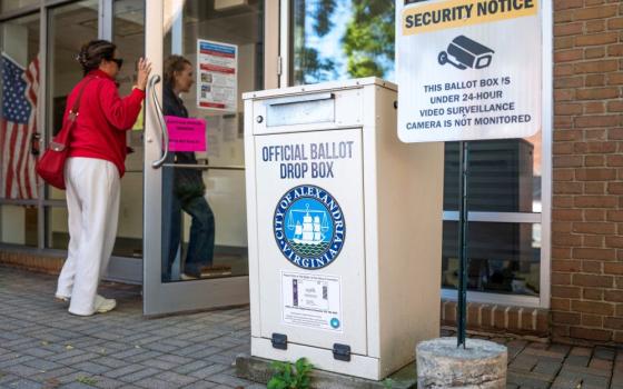 People walk past a ballot drop box during early voting at the Alexandria City Registrar Office in Virginia Oct. 7, 2026. (OSV News/Reuters/Nathan Howard)