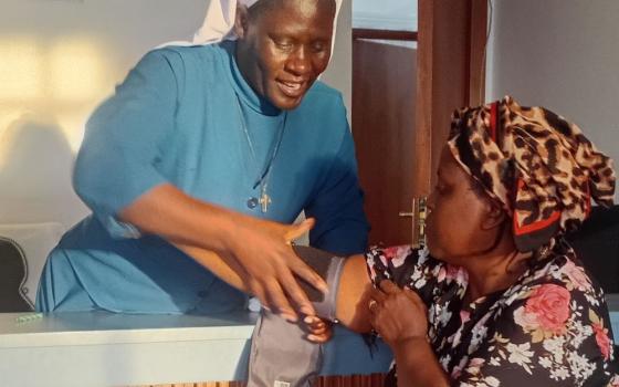 Sr. Teresa Barongo, a member of the Assumption Sisters of Eldoret and a nurse at the Dorothea Health Centre, greets a patient in Nairobi, Kenya. (Shadrack Omuka)