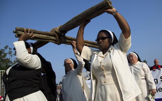 Nuns carry a cross during a silent march during Good Friday celebrations in Durban, South Africa, March 25, 2016. (CNS/Reuters/Rogan Ward)