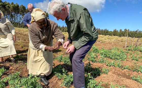 Sister Veronica, a member of the Little Sisters of St. Francis, shows a representative of the U.S. International Development Finance Corporation produce from the Divine Mercy Green Farm her order operates in Nakuru, Kenya. (CNS/Handout, Missio Invest, Pontifical Missionary Societies in the United States)