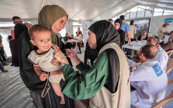 A child is screened for malnutrition in a camp in Gaza, where MedGlobal has nutrition outpatient clinics, October 2025. (Courtesy of MedGlobal)