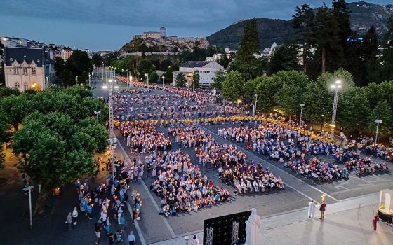 The night procession at 9 p.m. attracts thousands of visitors. It starts and ends in front of the Basilica of Our Lady of the Rosary in Lourdes, France. (GSR photo/Elisabeth Auvillain)