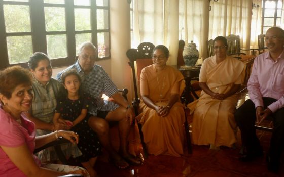 Sr. Jyothi Kerketta and Sr. Celine Sebastian of the Daughters of St. Paul converse with a family in the Fontainhas neighborhood of Panjim India. (Lissy Maruthanakuzhy)