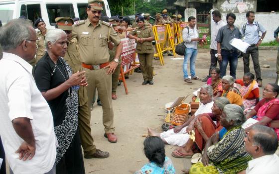 Gonzaga Sr. Anthonysami Alphonsa, standing between officers at left, addresses a meeting of Dalits in a village in the southern state of Tamil Nadu, India. (Provided photo)