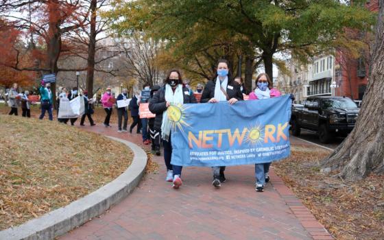 From left: Humility of Mary Sr. Eilis McCulloh, St. Joseph Sr. Erin McDonald, and Mercy Sr. Mara Rutten participate in a December 2021 demonstration at the White House that encouraged President Joe Biden to end Title 42.