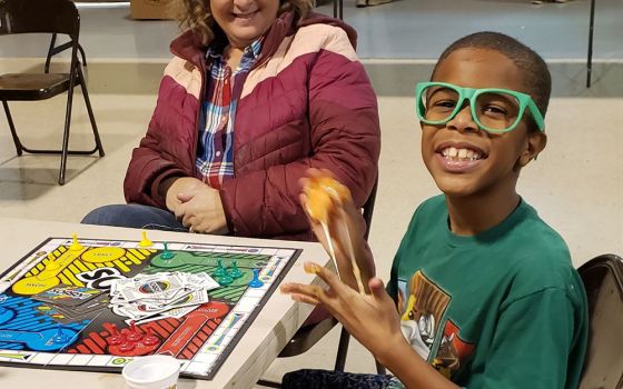 Shane, age 7, enjoys some attention two days after his family lost everything when the tornado swept through Graves County, Kentucky, on Dec. 10, 2021. He claimed the green sunglasses to help him cope and created a fun exchange with our volunteers.