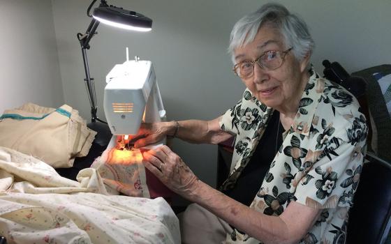 Sr. Jane Gates, MD, the first superior general of the Medical Mission Sisters after its founder. Sister Jane, 93 years old and a former surgeon, finds that her hands are still steady enough to sew gowns for medical care providers during the pandemic. (Eun