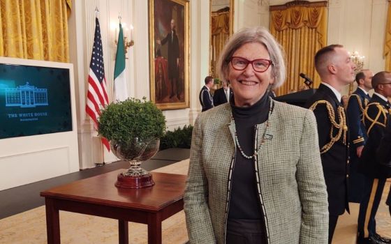 Social Service Sr. Simone Campbell poses with a bowl of shamrocks, a gift from the nation of Ireland to the United States, on March 17 [2022] at a St. Patrick's Day celebration at the White House in Washington, D.C. (Courtesy of Sr. Simone Campbell)