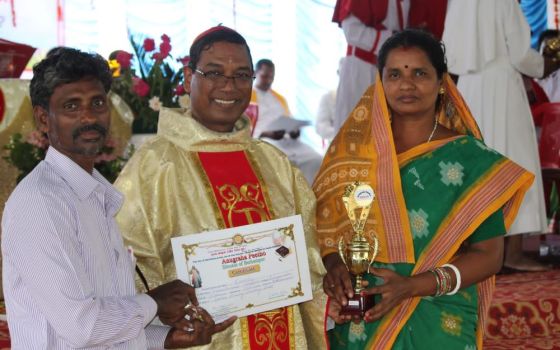 Lalita Beero and her husband receive recognition April 24 from Bishop Sarat Chandra Nayak. (Sujata Jena)
