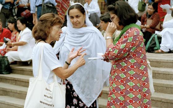 Women discuss the issues at the Non-Governmental Organizations Forum held in Huairou, China, Sept. 3, 1995, as part of the United Nations Fourth World Conference on Women held in Beijing. (U.N. Photo/Milton Grant)