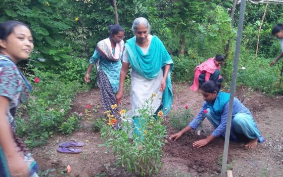 Sister Molly, manager of the farm at Deepalaya, run by the Medical Mission Sisters in Khandwa, Madhya Pradesh, India, leads novices in planting. (Courtesy of Celine Paramundayil)