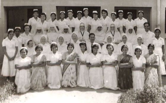 Members of the faculty and student body of the newly opened school of nursing at Nazareth Hospital in Mokama, India, in October 1953. The students are a mix of Indian women and nuns from other orders, pictured in full white veils and wimples.