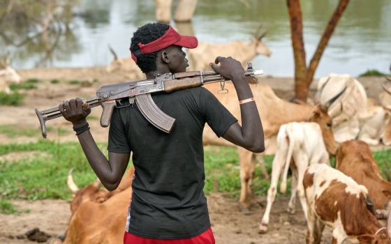 A cattle keeper holds an assault rifle in Mogok, South Sudan, Sept. 1, 2021.(CNS photo/Paul Jeffrey)