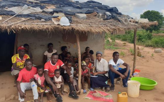 Good Shepherd Sr. Eva Ribeiro, in white blouse, and project manager Pirai Oriente, in red T-shirt with white trim, work with displaced families from Cabo Delgado province, Mozambique. (Courtesy of Eva Ribeiro)