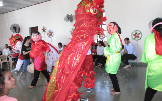 Five sisters of the Daughters of Our Lady of the Visitation perform a lion dance in colorful costumes to bring good luck and fortune to 30 children in their community in the Huong Thuy district of Thua Thien Hue province Sept. 7. 