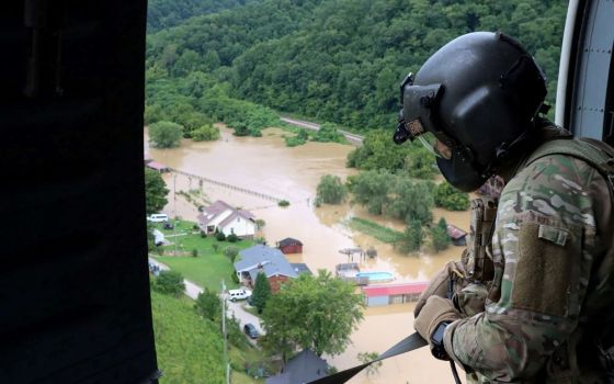 A Kentucky National Guard flight crew from 2/147th Bravo Co. flies over a flooded area in response to a declared state of emergency in eastern Kentucky July 29, 2022. (CNS/Reuters/Sgt. Jesse Elbouab, U.S. Army National Guard)