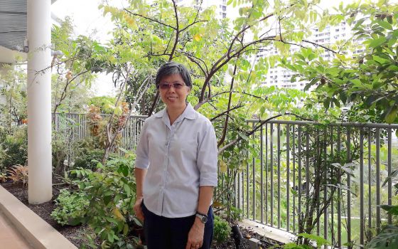 Good Shepherd Sr. Agnes-Claire Koh poses in front of the Good Shepherd Sisters' main convent; public housing can be seen in the background. (Provided photo)
