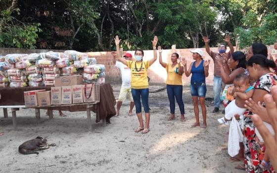 Sr. Maria Odete Pereira, center, of the Congregation of the Immaculate Heart of Mary gives thanks before the distribution of food baskets to residents of the Our Lady of Fatima community just outside of Manaus, Amazonas state, Brazil. (Courtesy of Sr. Ros