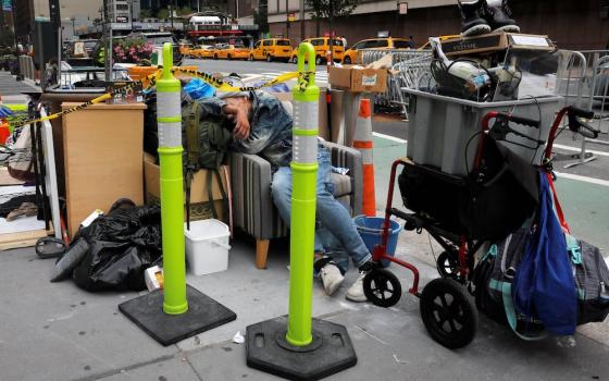 A homeless person in New York City sleeps among belongings Aug. 31. (CNS/Reuters/Mike Segar)