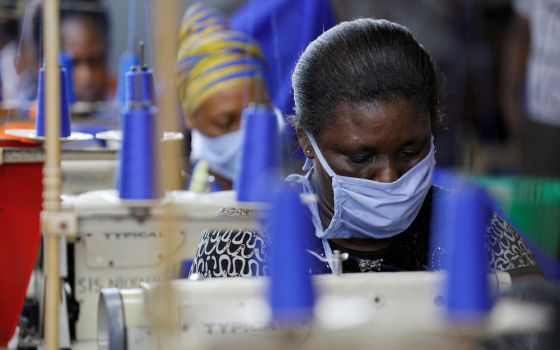 Workers of an Accra, Ghana, factory begin the production of personal protective gear for local frontline health workers April 10, 2020, during the coronavirus pandemic. (CNS/Reuters/Francis Kokoroko)