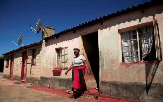 A woman walks out of her family home in Harare, Zimbabwe, on May 9 during the COVID-19 pandemic. (CNS/Reuters/Philimon Bulawayo) 