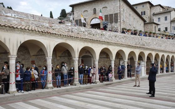 People wait to see Pope Francis outside the Basilica of St. Francis in Assisi, Italy, Oct. 3. The pope celebrated Mass and signed his new encyclical, " 'Fratelli Tutti,' on Fraternity and Social Friendship," in the crypt of the basilica. (CNS/Paul Haring)