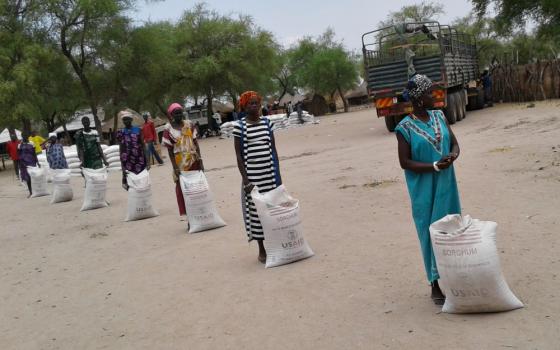 Participants in a U.S. Agency for International Development food security program practice social distancing while waiting to receive food rations at a food-for-assets distribution in Duk, South Sudan, on April 2. (Courtesy of Catholic Relief Services)