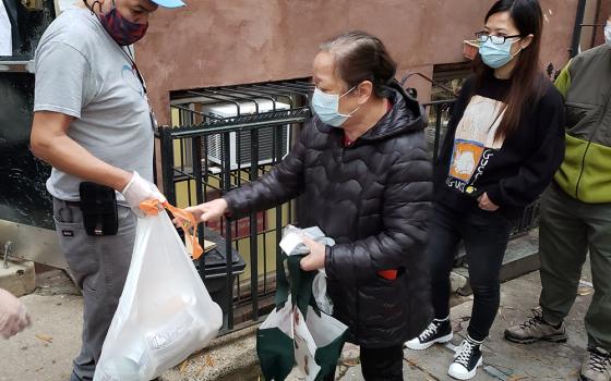 Those in line for food packages outside Cabrini Immigrant Services on Oct. 27 received a frozen chicken, milk, tea, rice, beans, potatoes and other vegetables. Many of those receiving the packages are elderly neighborhood residents of Chinatown, who thems