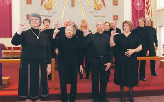 Sr. Conchetta LoPresti, left, signs "Lord" with the sign choir during a 2013 Mass at Resurrection Parish in Cheektowaga, New York. (Courtesy of Sisters of St. Francis of the Neumann Communities)