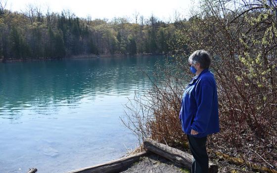 Sr. Caryn Crook, vocation director for the Sisters of St. Francis of the Neumann Communities, enjoys the view of Green Lake while members of the House of Discernment community visited Syracuse, New York, in late April. (Julie A. Ferraro)