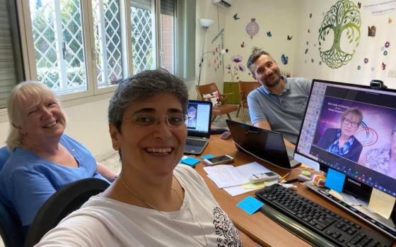 Good Shepherd Sr. Mary Farren, left, Good Shepherd Sr. Monique Tarabeh and technical consultant Marco Grottesi pause while working in Rome on the congregation's intercontinental assemblies, which were held virtually between August and October. (Courtesy o