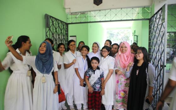 Happier times: the students at Holy Cross College take a group photo before the COVID-19 pandemic. (Sumon Corraya)