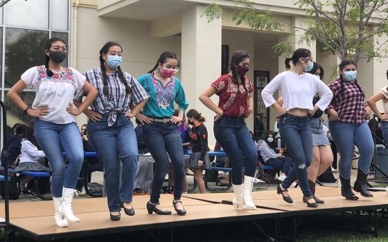 Lupita Castañeda-Liles, fourth from the left, takes part in a performance of a Mexican folkloric dance group she is part of at Notre Dame High School in San José, California. (Courtesy of Monica Gomez)