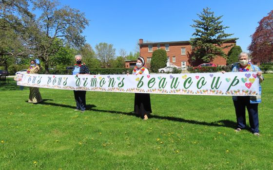 Sisters of Providence held a banner to let other sisters in the community who were isolated because of COVID-19 restrictions know they were appreciated and loved. The gesture was done several times throughout the pandemic, in rain as well as sun. (Courtes
