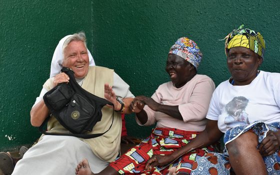Sr. Judith Bozek, a Missionary Sister of the Holy Family, shares a light moment with Esnart Kangwa (in pink shirt), one of the elderly residents at the Cheshire Divine Providence Home, located in a large slum just southwest of Lusaka, Zambia.